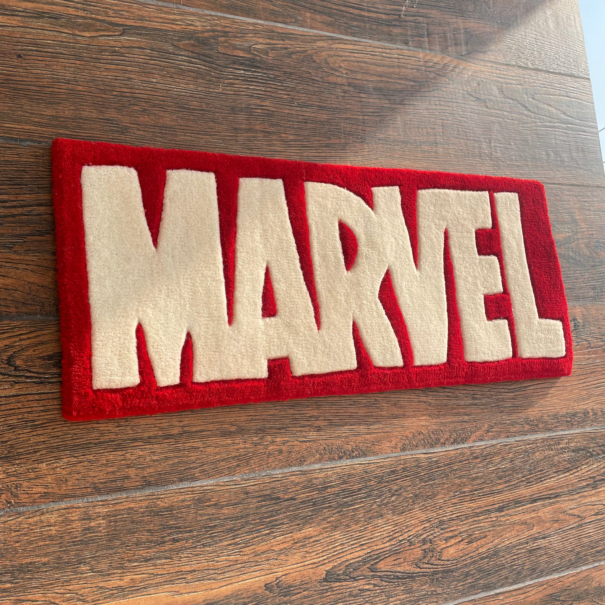Marvel Logo Hand-Tufted Rug on wall