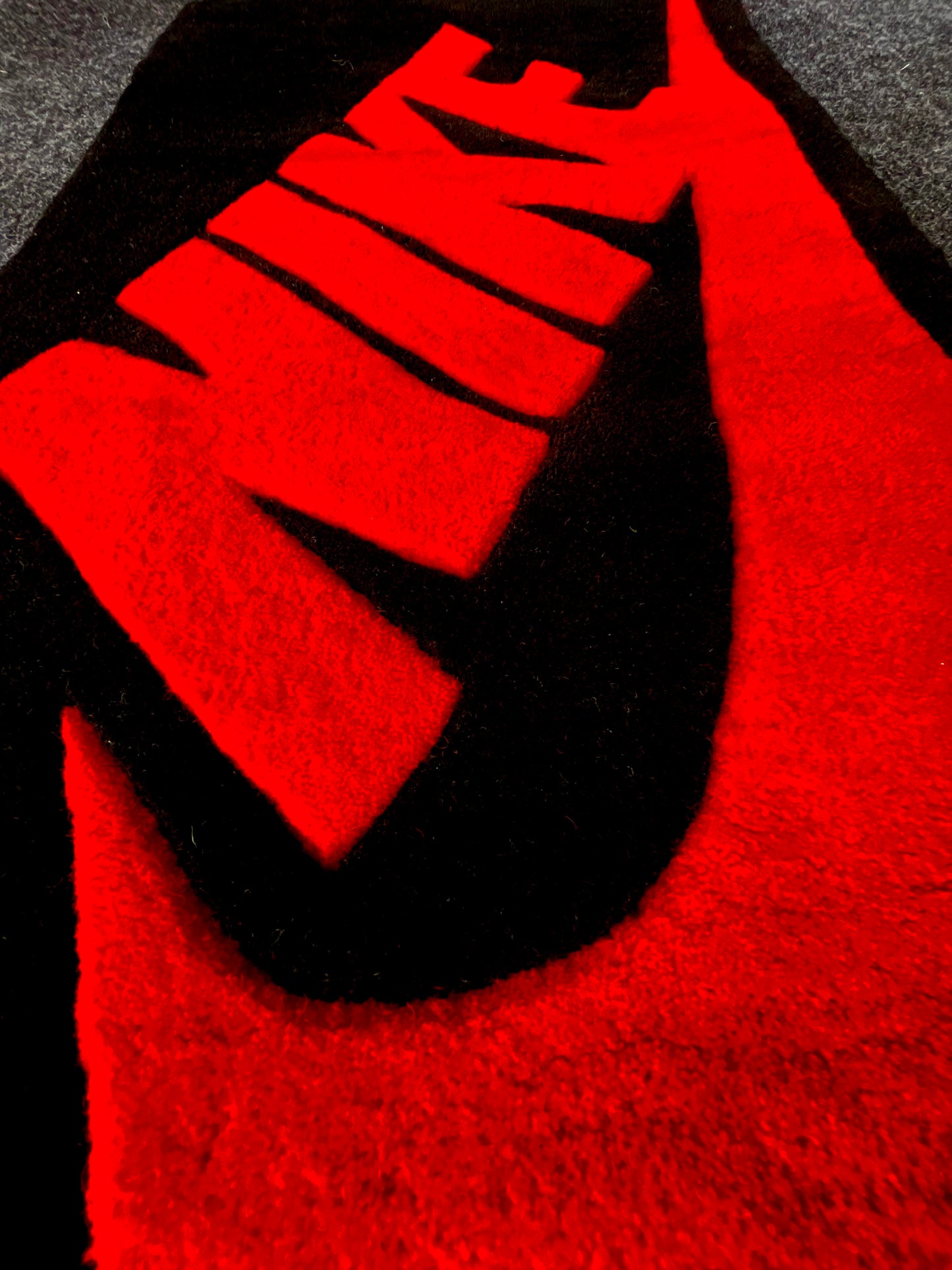 Nike Red and Black Hand-Tufted Rug closeup