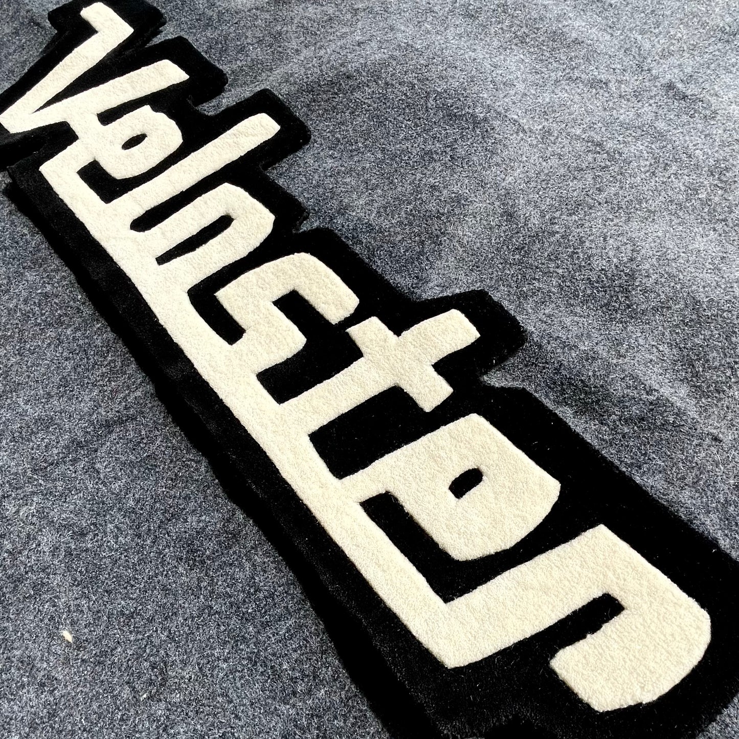 Veloster Typography Hand-Tufted Rug
